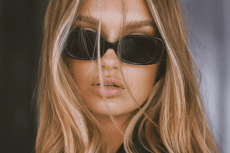 Woman with glossy, healthy-looking blonde hair after using repairing hair treatments