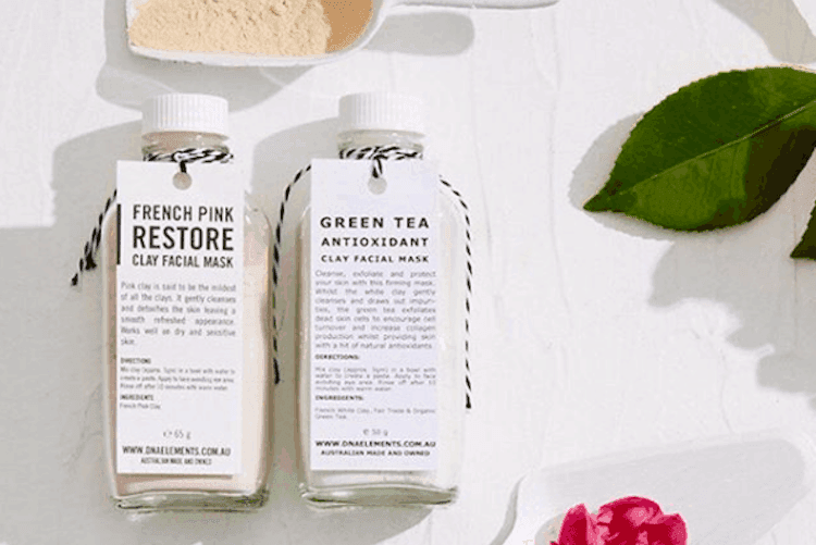 Minimalist beauty product bottles and containers arranged on a neutral surface showcasing sustainable Australian skincare brands