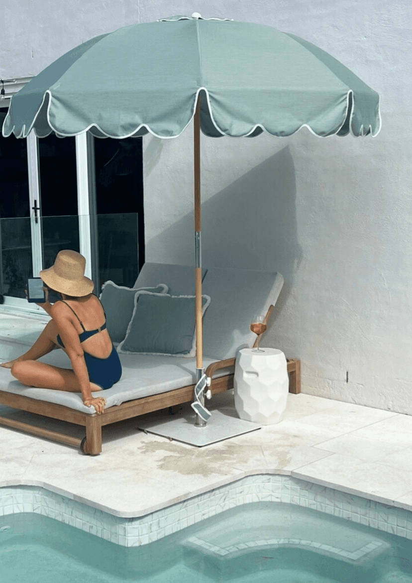 Woman applying sunscreen poolside