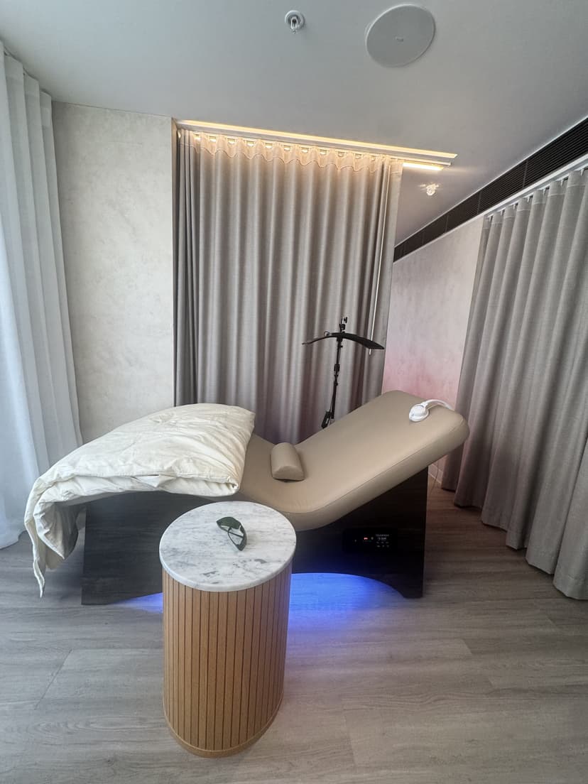 The vibroacoustic bed in the recovery lounge at Eliva Spa, lit blue underneath, with a marble side table