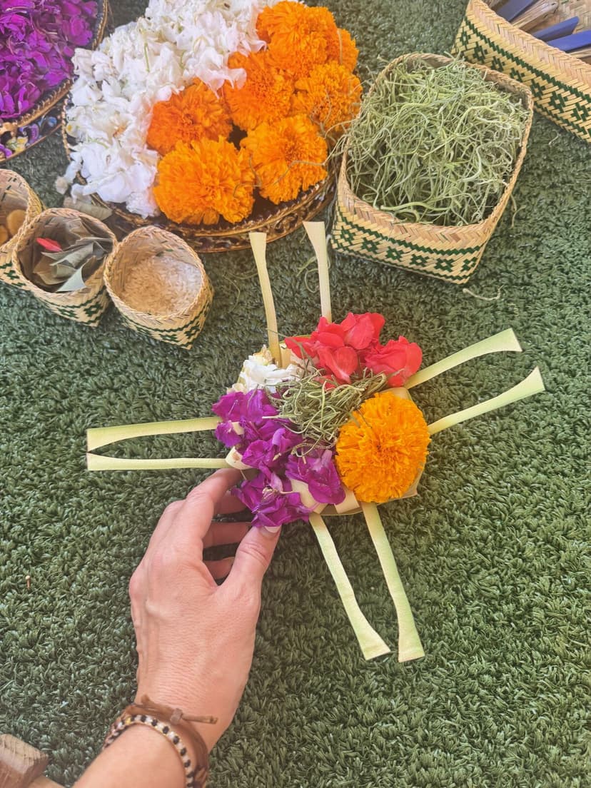 Canang sari flower offering being made by hand at Paradisus Bali welcome ceremony