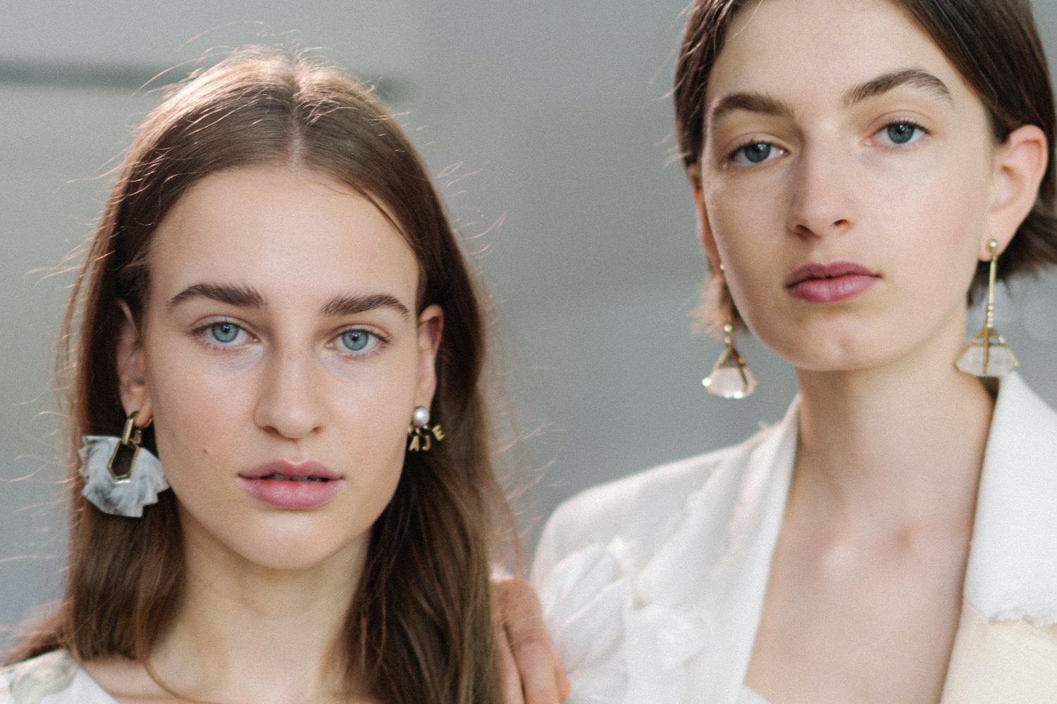 Model with glowing, hydrated skin and natural makeup at fashion presentation