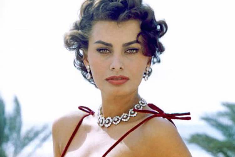 Sophia Loren with signature cat eye makeup, red lip and tousled honey brunette hair
