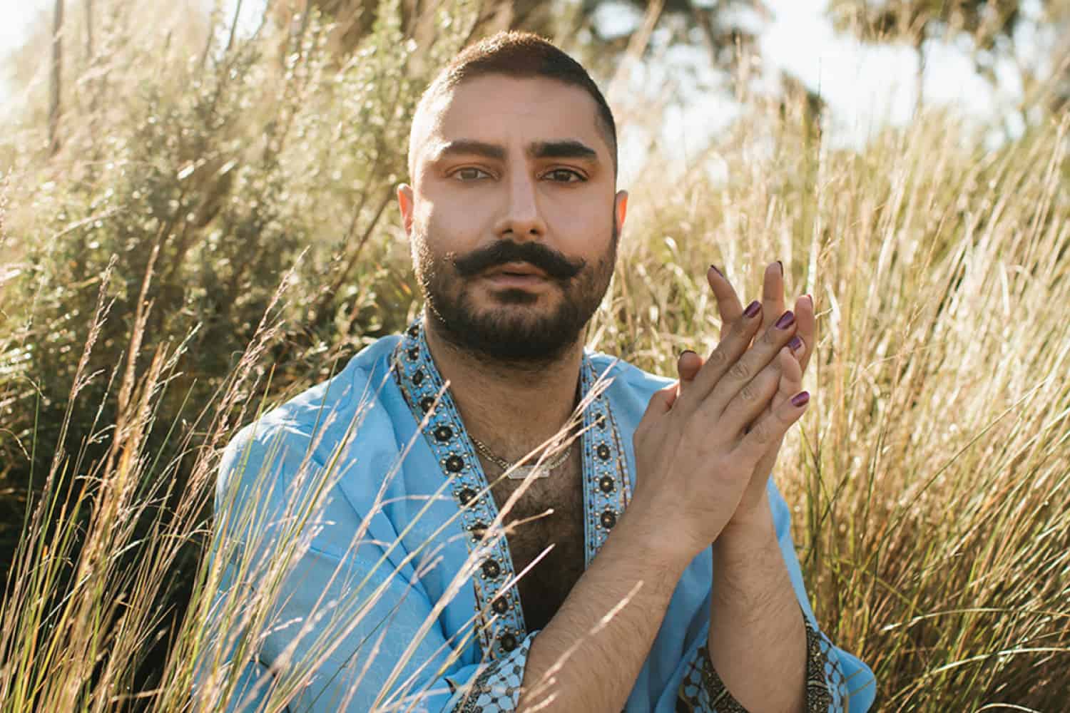 Deni Todorovič, non-binary fashion editor and queer educator, wearing bold colourful styling