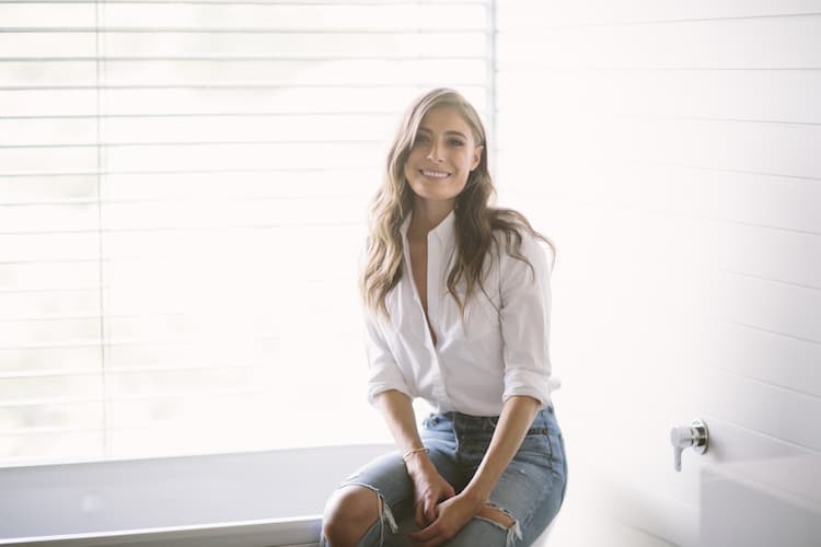 Rebecca Harding in her light-filled Melbourne home wearing minimal makeup and a neutral knit