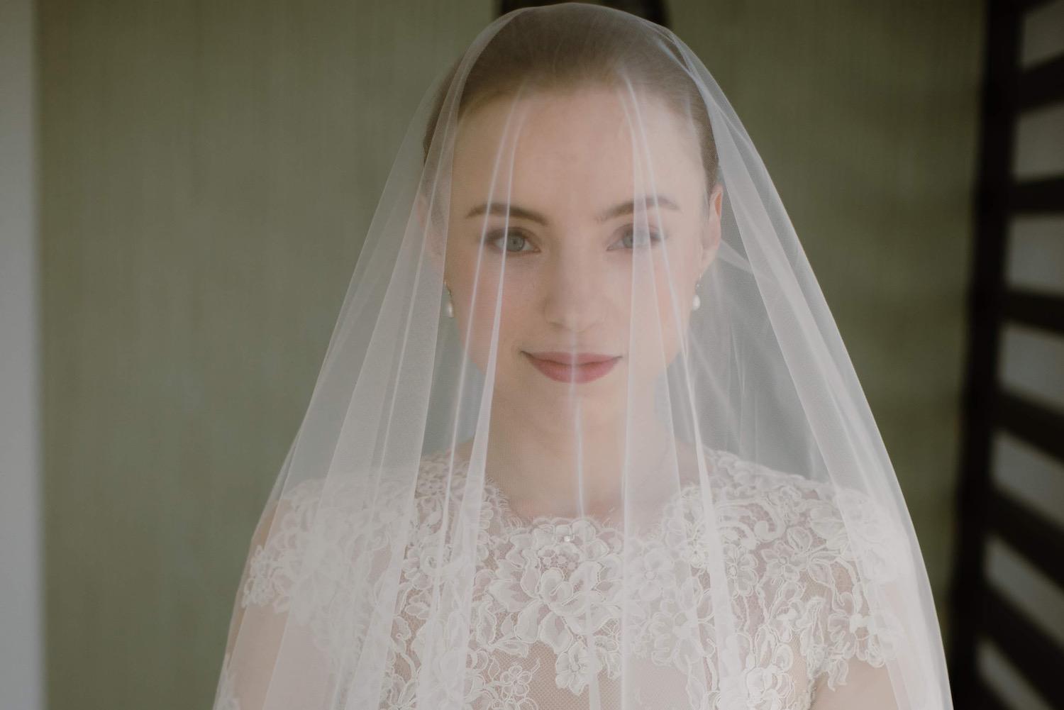 Bride with glowing skin and natural nail polish on wedding day