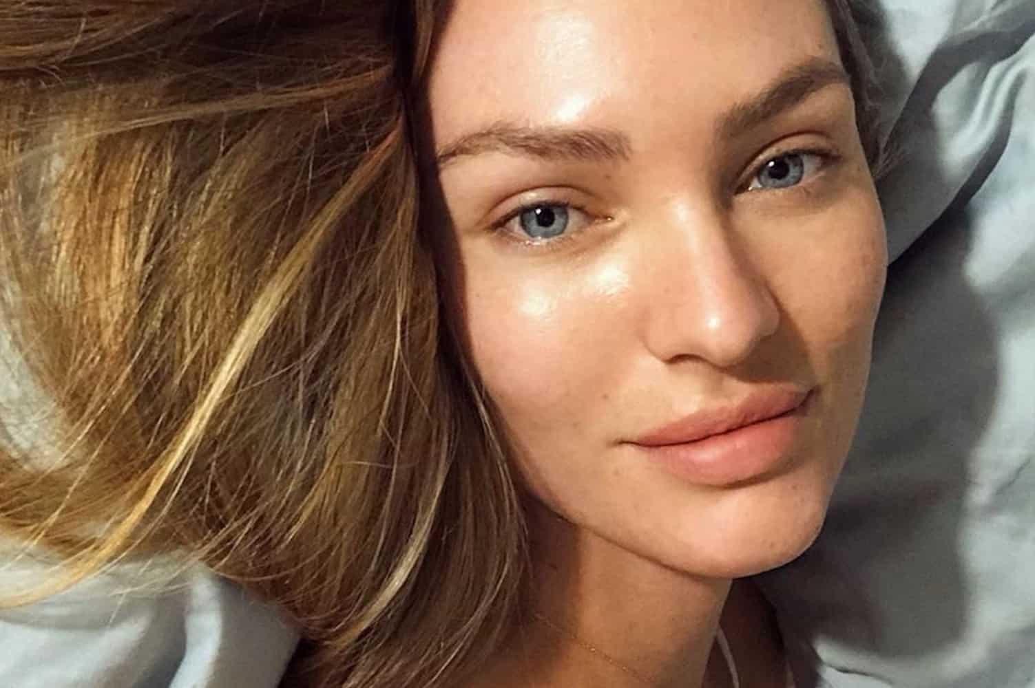 Woman with oily skin examining lightweight anti-ageing serum in minimalist bathroom setting
