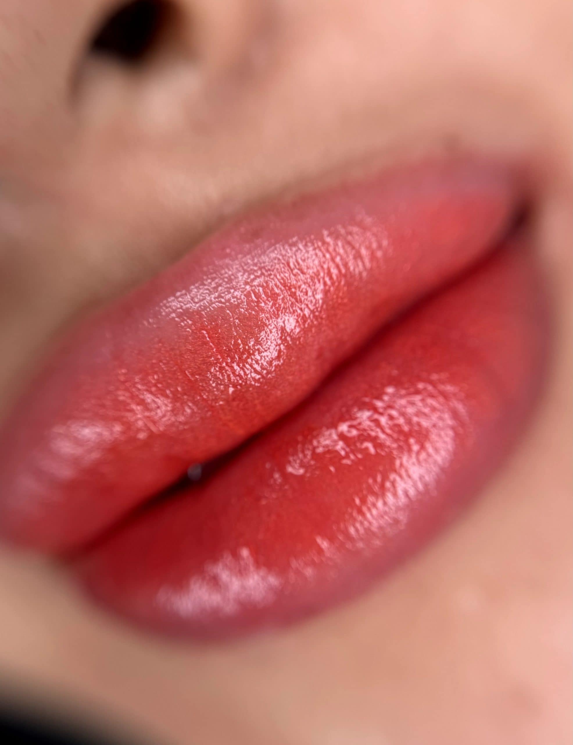 Lips immediately after lipstick tattoo — intense colour and swelling