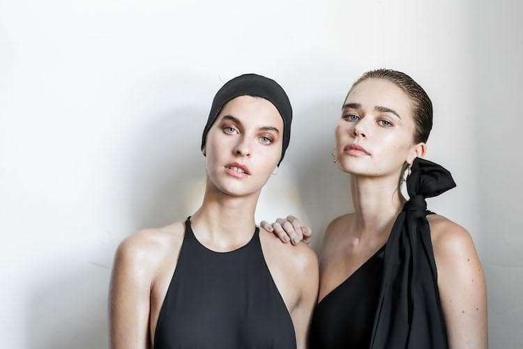 Models backstage at Mercedes Benz Fashion Week Australia with professional makeup and styling