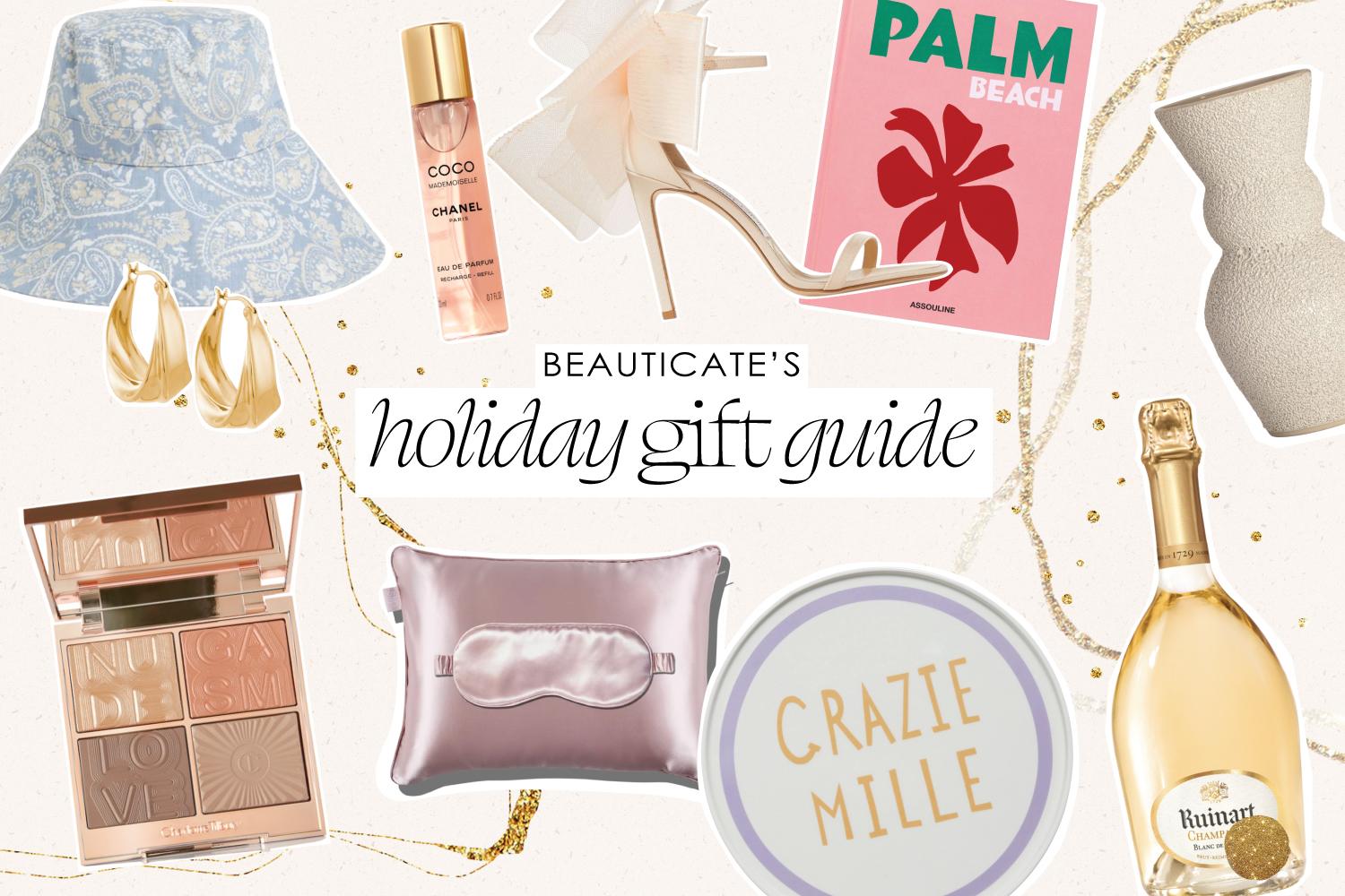 Curated luxury Christmas gift collection featuring swimwear, skincare, accessories and champagne on marble surface