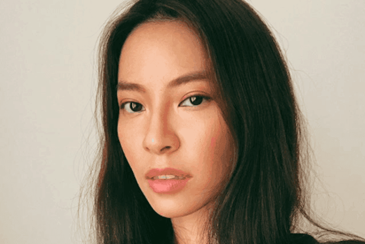 Woman with glowing skin holding Asian beauty products including konjac sponge and cushion compact foundation