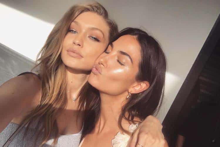 Woman with glowing, radiant skin applying serum to her face