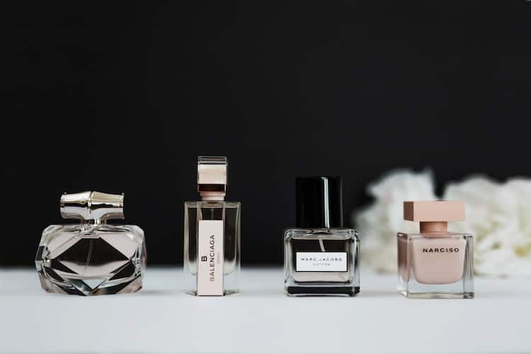 Curated selection of winter perfume bottles displayed on neutral background