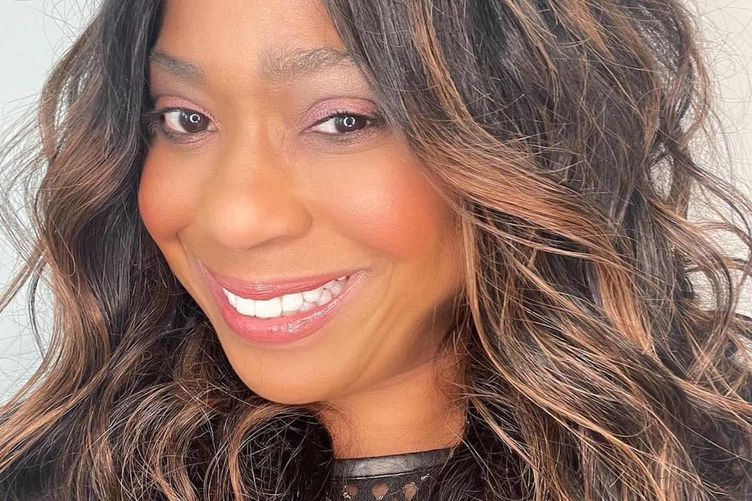 Camille Friend styling actress on Black Panther film set with elaborate tribal-inspired hair design