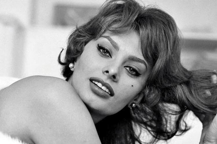 Sophia Loren with voluminous brunette hair in a classic black-and-white portrait