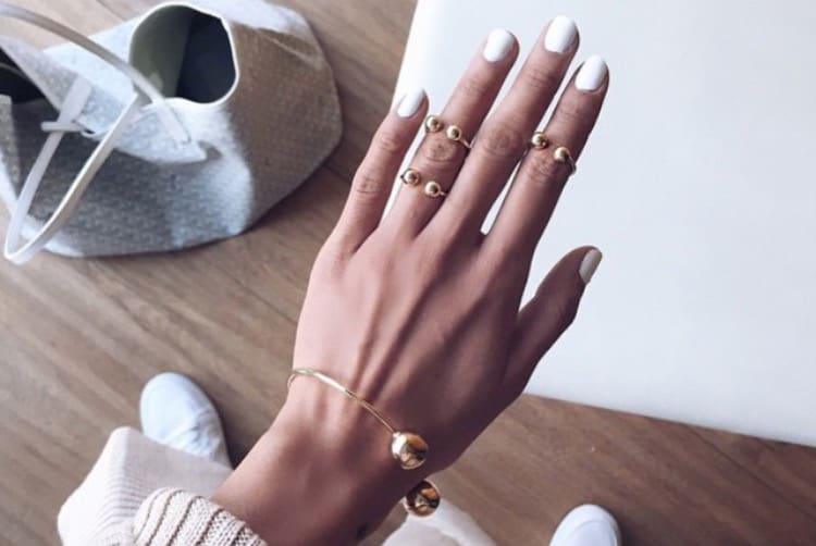 Collection of summer nail designs featuring oval shapes, pastels, glitter and coral manicures on tanned skin