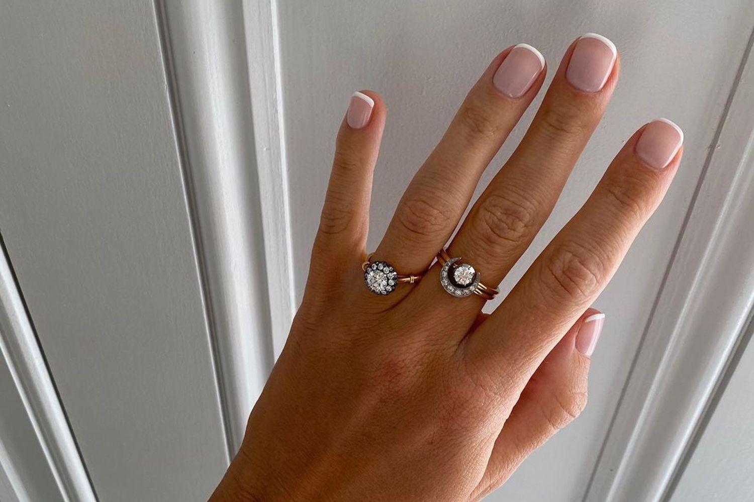 Close-up of natural, polished nails with peachy sheer finish and clean cuticles on manicured hands
