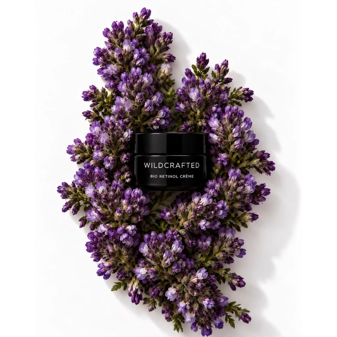 Wildcrafted Organics Bio Retinol Crème jar resting on a bed of purple flowering sprigs
