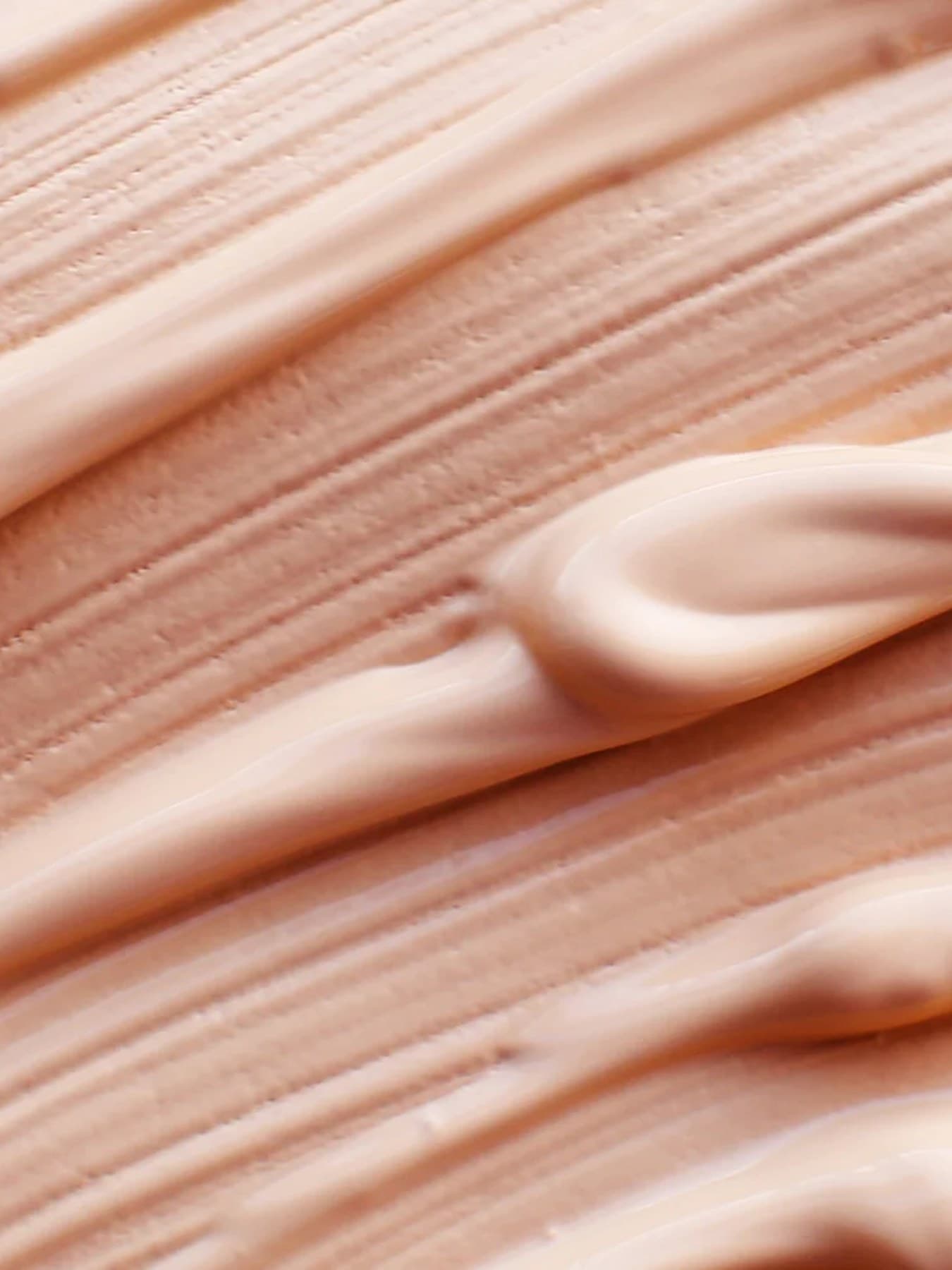 Close-up of the smooth, creamy texture of a peachy-beige cream