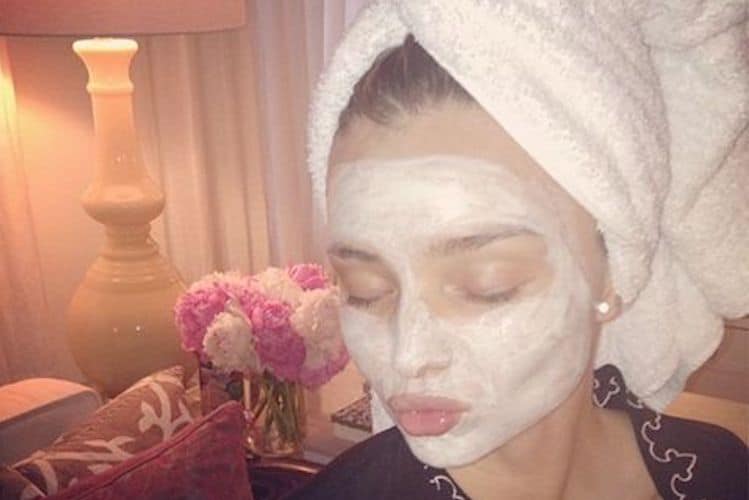 Selection of premium face masks including sheet masks, mud masks and cream formulas arranged on marble surface