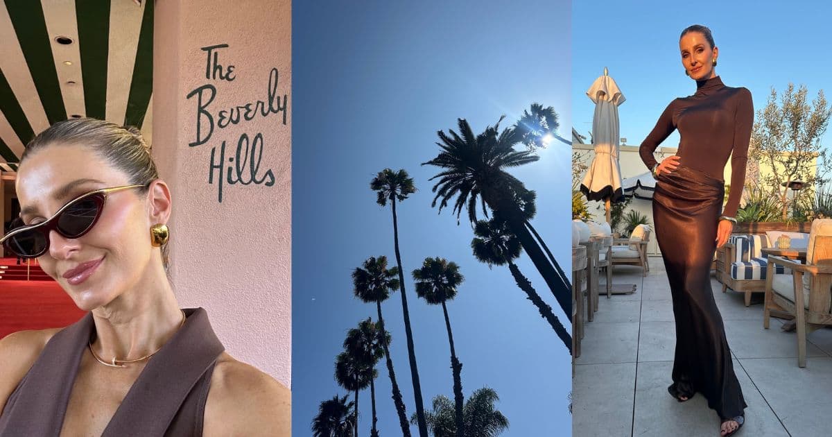 Kate Waterhouse taking a selfie outside The Beverly Hills Hotel beside the pink wall with green script lettering, wearing tortoiseshell cat-eye sunglasses and gold statement earrings