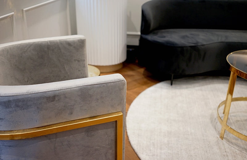 Amy Jean Brows salon interior with velvet seating, gold accents, and herringbone floors