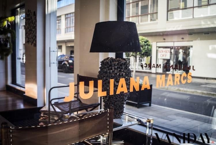 Luxurious hair salon interior with gold Baroque accents, spherical copper counter and client styling chairs with ornate mirrors