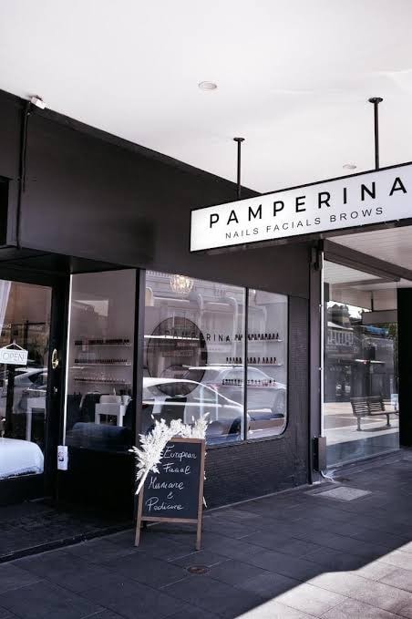 Black shopfront of Pamperina on Edgecliff Road, Woollahra, with a chalkboard and dried flowers by the door