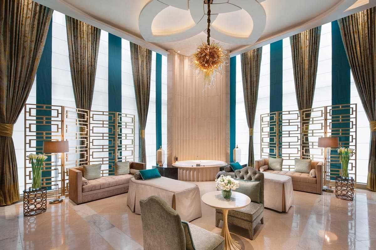 Opulent spa reception with glass blown butterflies and La Prairie product displays at Crown Towers