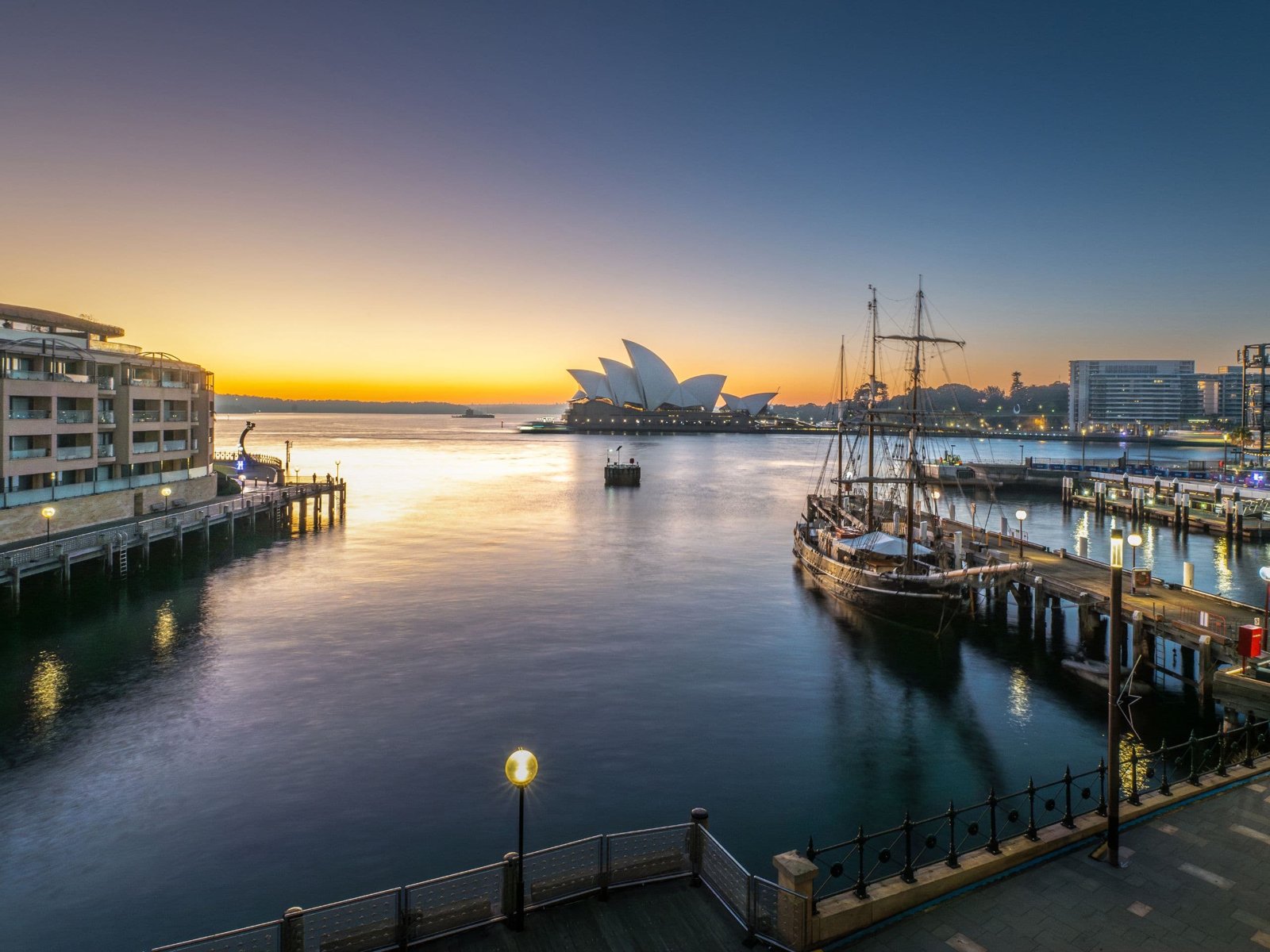 Park Hyatt Sydney on the water at Campbells Cove, looking across the harbour to the Opera House at sunrise