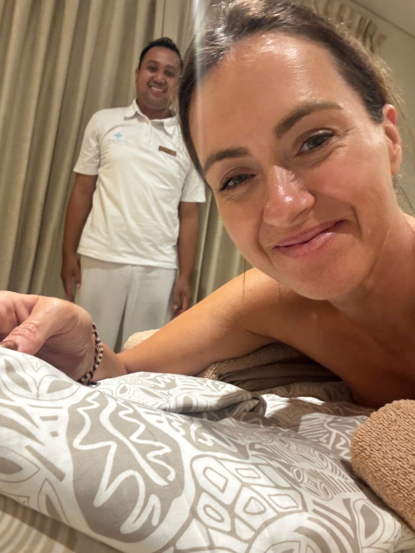 Sigourney on the massage table at Escape Haven with Ngurah, the therapist who worked on her neck and shoulders every day