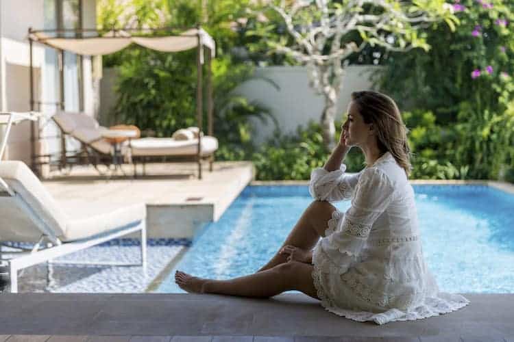 Luxurious beachfront villa at The Mulia resort with infinity pool overlooking tropical gardens and Bali coastline