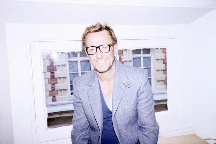David Mallett in his Paris salon surrounded by eclectic art, sculptures and a stuffed ostrich named Babeth