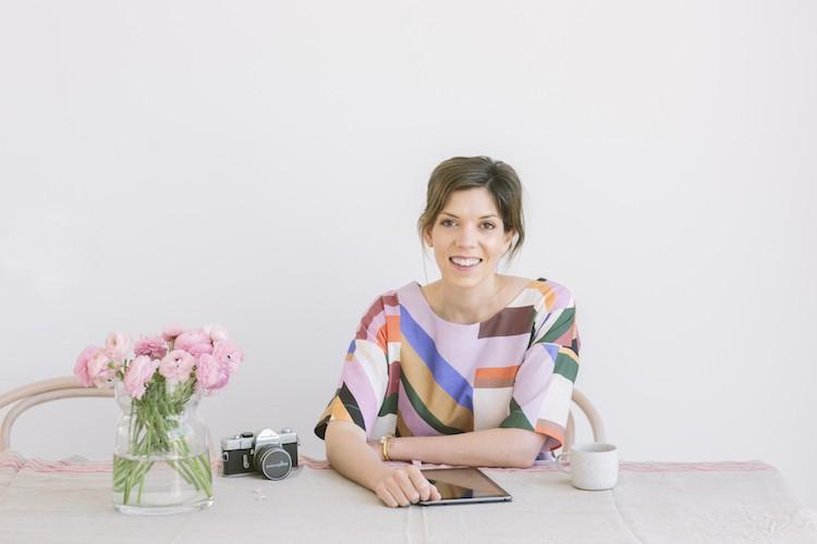 Lucy Feagins, founder of The Design Files, in a minimalist studio setting with natural lighting