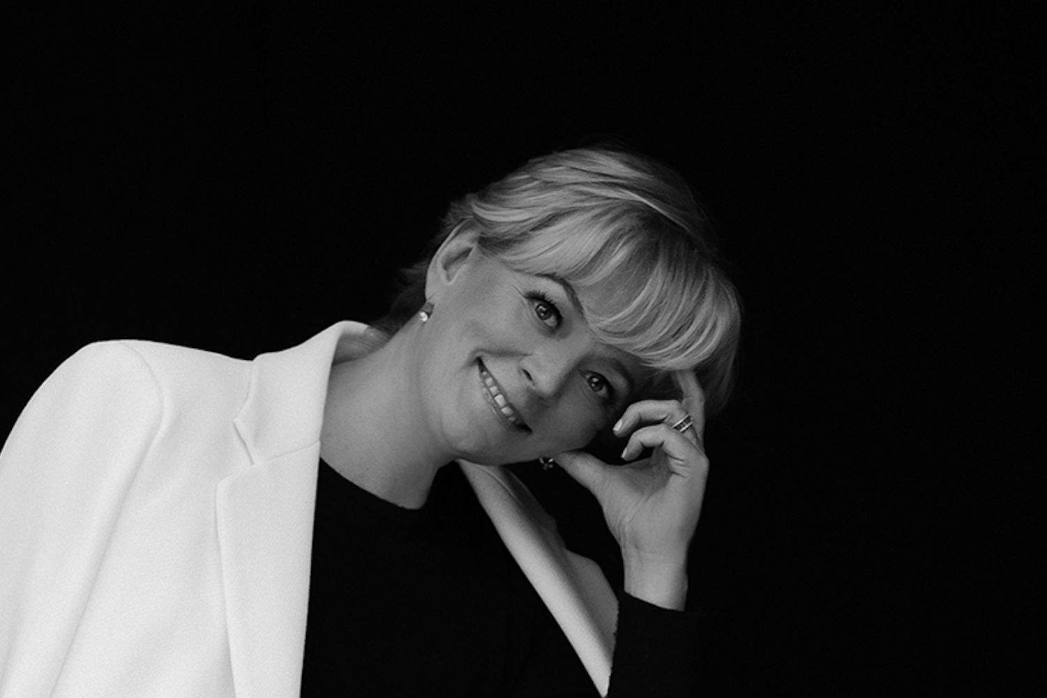 Jo Malone standing outside the Jo Loves flagship store in London, wearing elegant styling