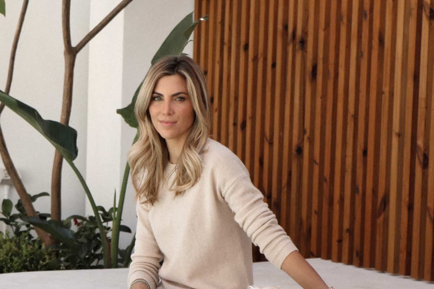 Well-groomed woman with glowing skin, neutral makeup, and styled hair in professional beauty setting