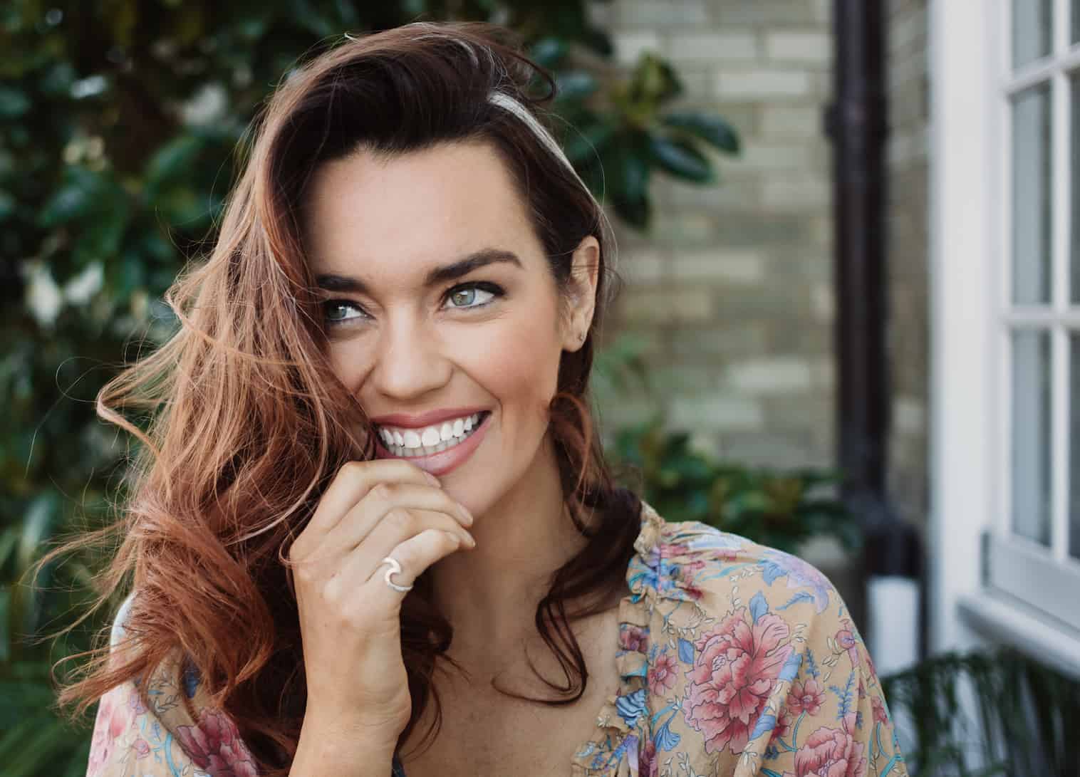 Model Laura Wells in natural light, wearing sustainable fashion, embodying eco-conscious beauty