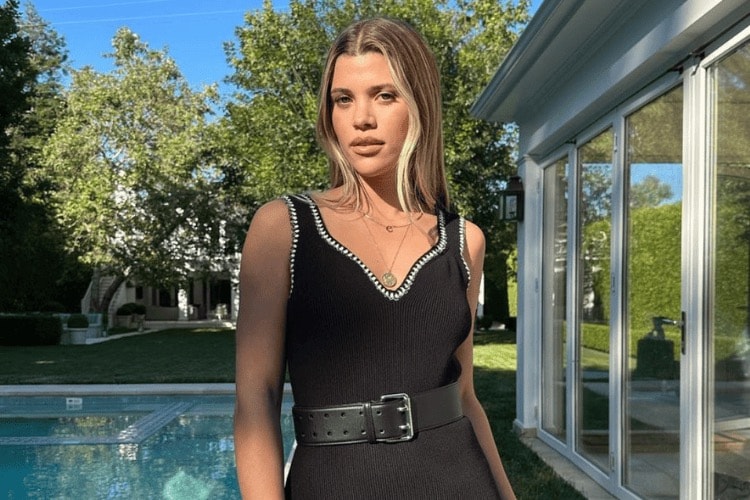 Sofia Richie wearing a tailored blazer and minimalist makeup with nude lipstick, embodying her signature effortless aesthetic
