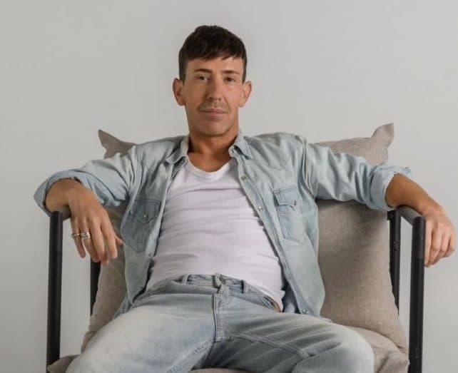 David the Medium, Australian psychic medium, relaxed in a chair in denim, Beautiful Inside podcast guest on Beauticate