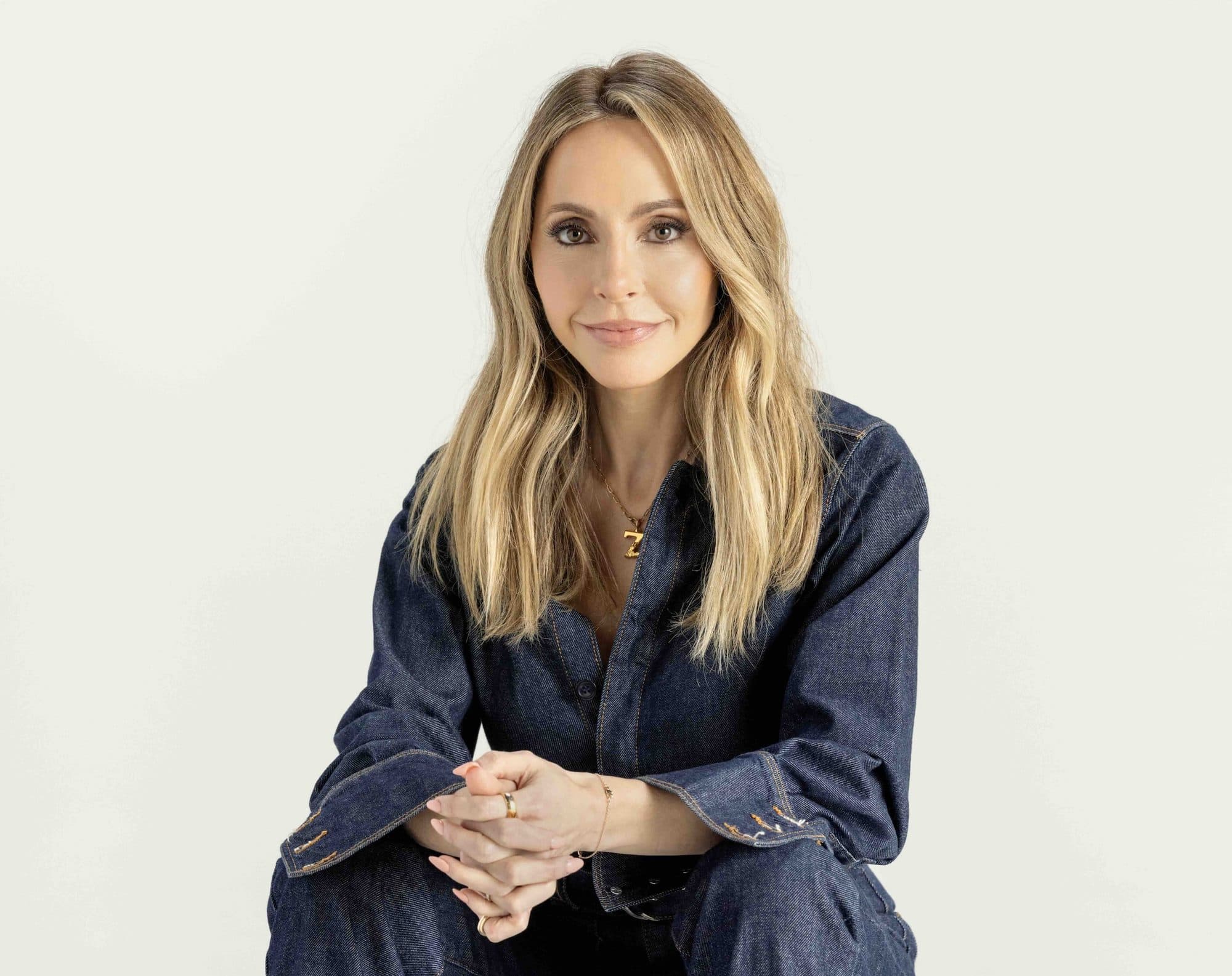 Spiritual teacher and bestselling author Gabby Bernstein in a denim shirt against a soft neutral backdrop, for Beautiful Inside by Beauticate
