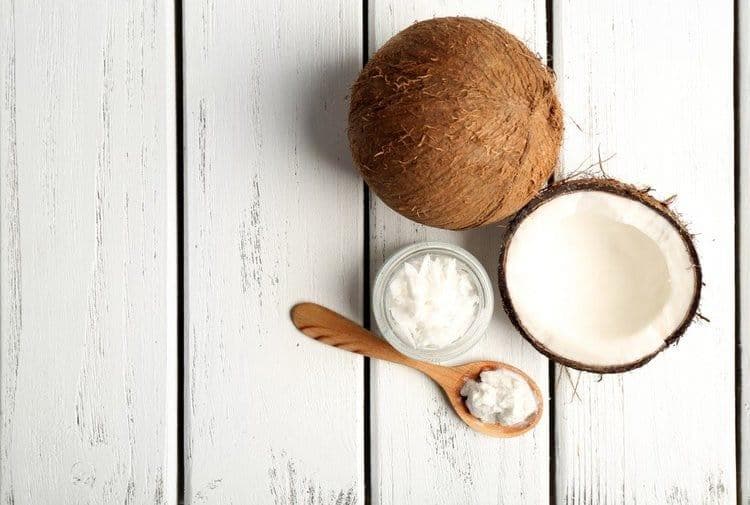 Woman swishing coconut oil in mouth during oil pulling detox ritual