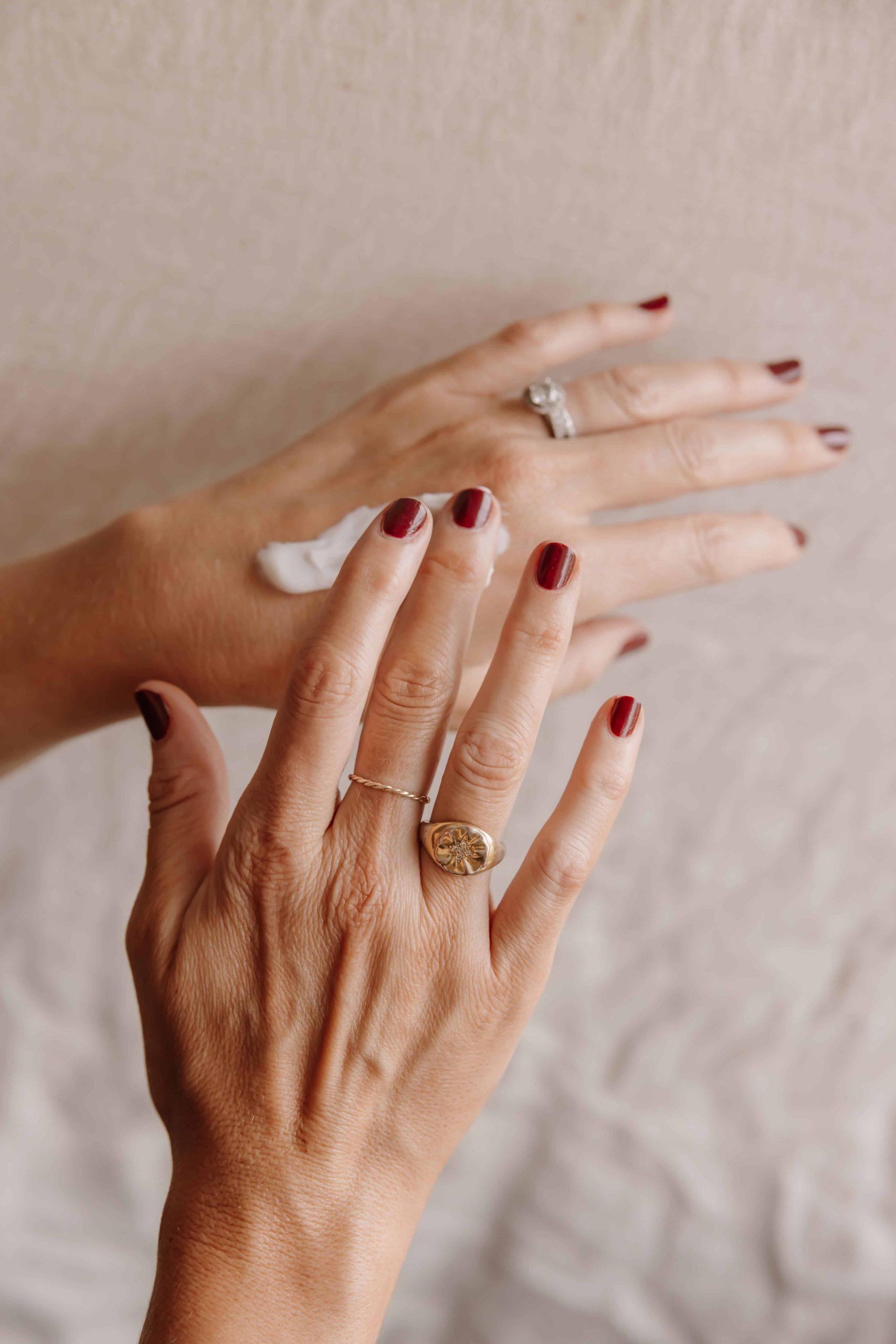 Hands smoothing the No 1 de Chanel Revitalising Cream between palms