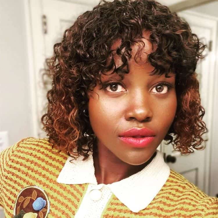 Camille Friend with HASK Curl Care products she helped develop for natural curls