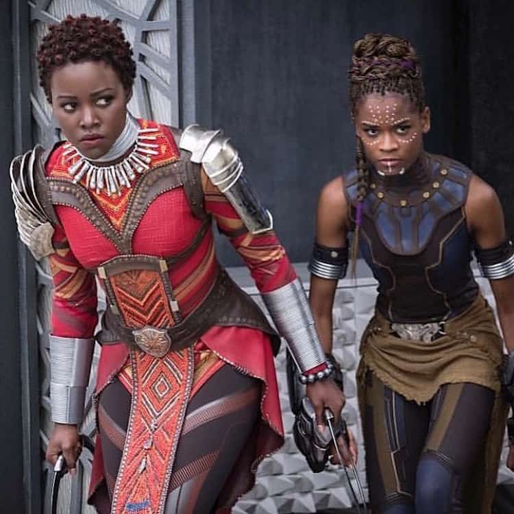 Lupita Nyong'o and Letitia Wright in Black Panther wearing hair looks designed by Camille Friend