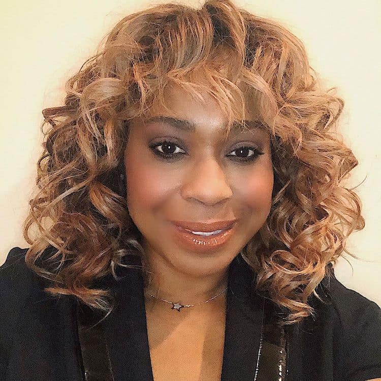 Camille Friend demonstrating curl care and conditioning technique