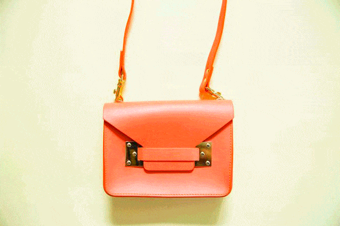 Bag by Sophie Hulme; Cardholder by Mischa; Shoes from a market in Hong Kong; Various Sunglasses; Kit Cosmetics Sunscreen; Marc Jacobs Daisy; Vaseline; Napoleon Lipgloss; Apple Iphone.