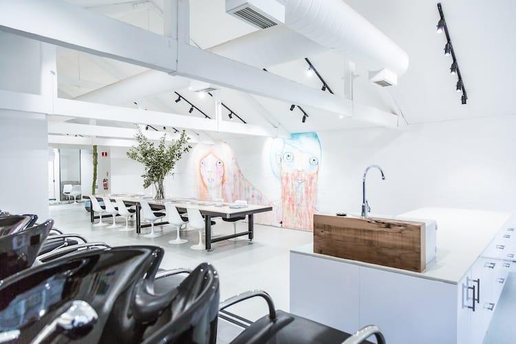 The communal table, wash basins and vibrant wall murals inside Edwards and Co Melbourne