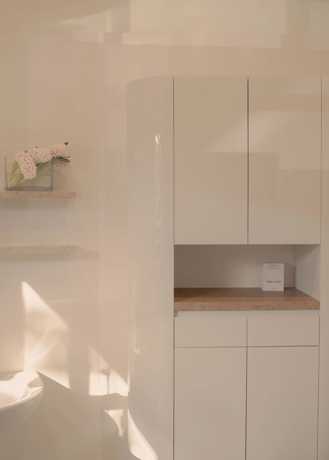 White built-in cabinetry in a treatment room at Rêve Skin + Beauty, Annandale
