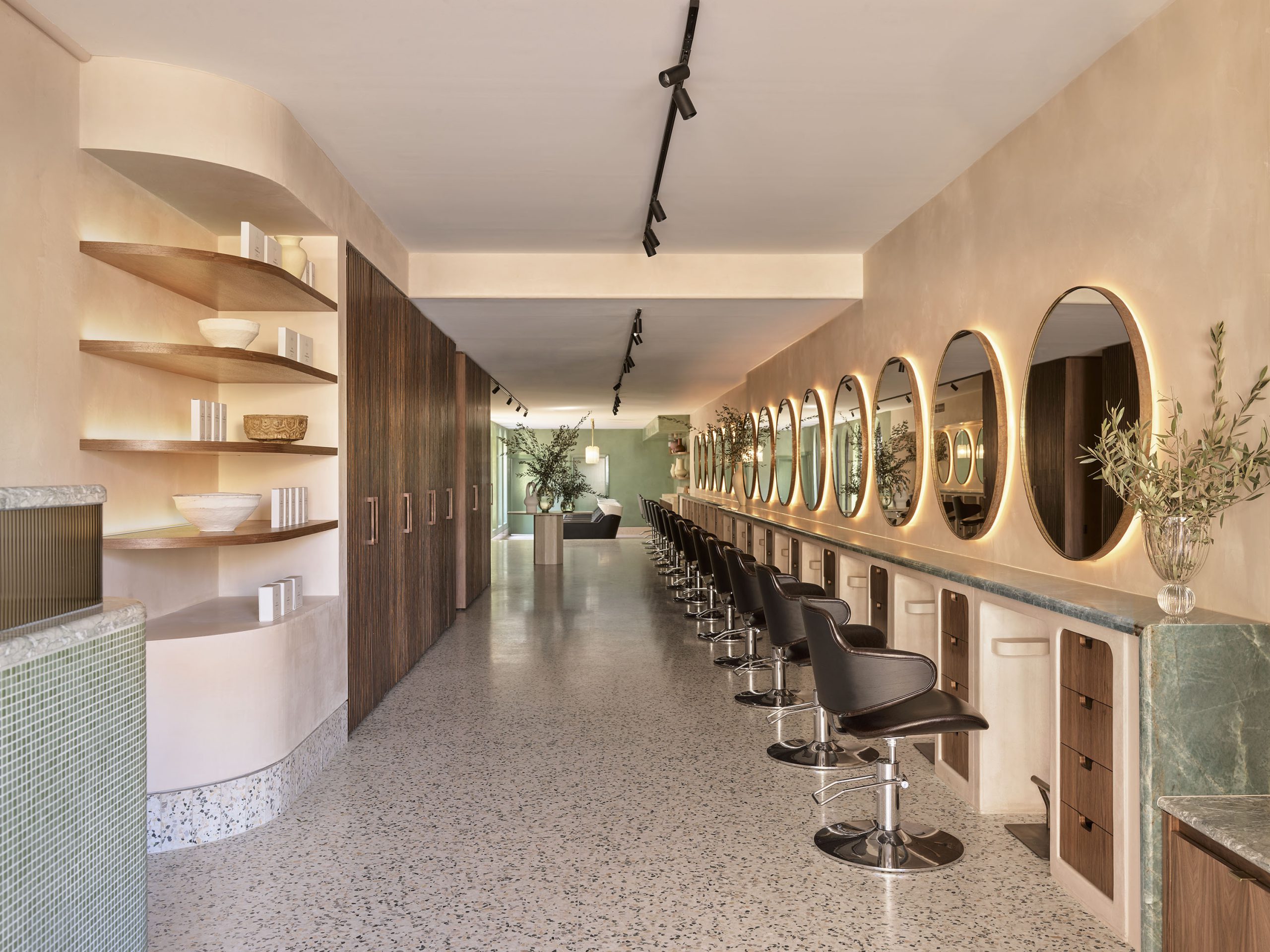Headcase Hair salon interior with mirrored walls and styling stations