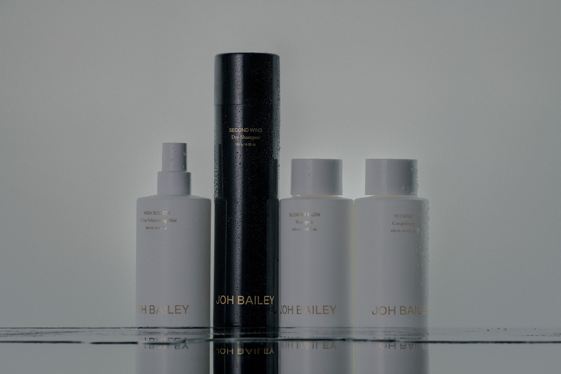 Joh Bailey's signature haircare range, including High Society Ultra Volumising Mist, Second Wind Dry Shampoo, Blow By Blow Shampoo and 10 Carat Conditioner